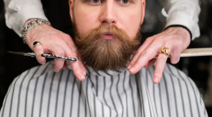 Men’s Grooming Guide: Beard, Shave and Skin Basics Bearded man receiving grooming at a barbershop