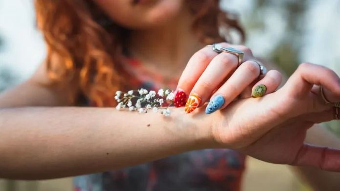 Colourful nail art design on the hand
