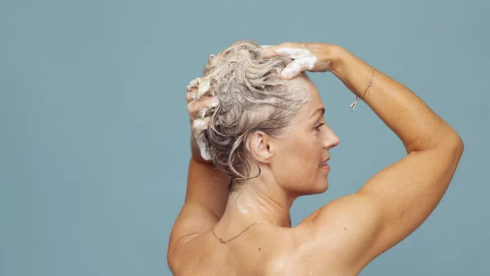 Purple Shampoo Blonde woman shampooing her hair to tone brassiness