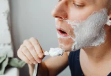 Razor Bumps and Ingrown Hairs: Prevention and Treatment Man shaving carefully at the bathroom mirror