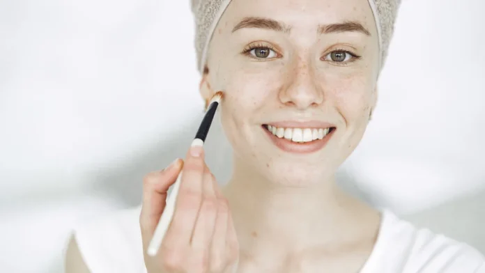 Woman touching up sun protection over her makeup with a brush