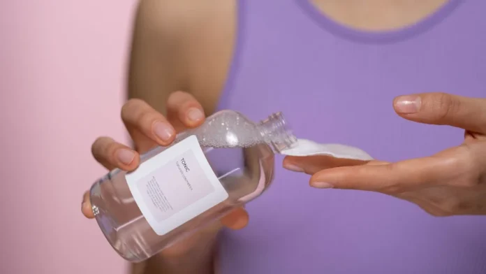 Applying salicylic acid toner with a cotton pad