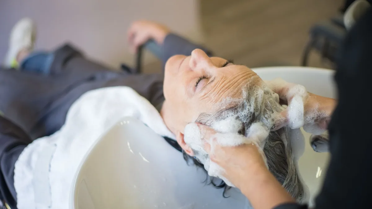 Woman having her scalp massaged during a hair wash