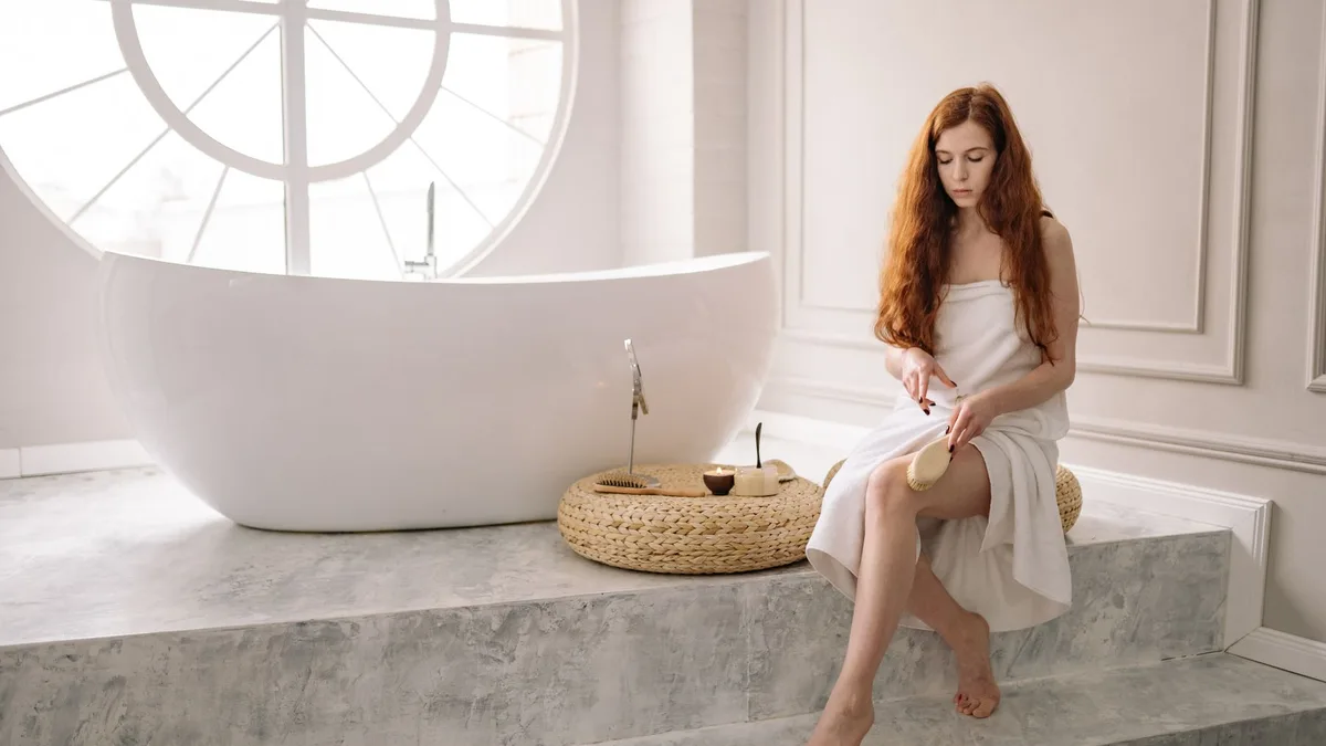Woman using a brush as part of a self-care routine
