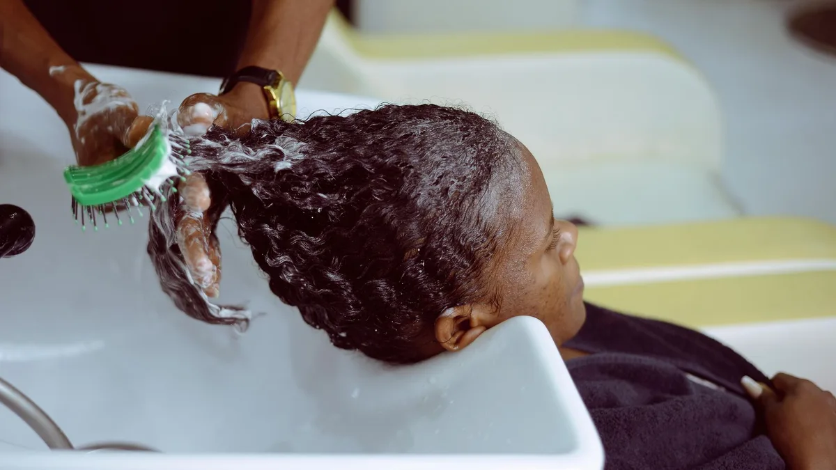Woman having her hair washed with lather