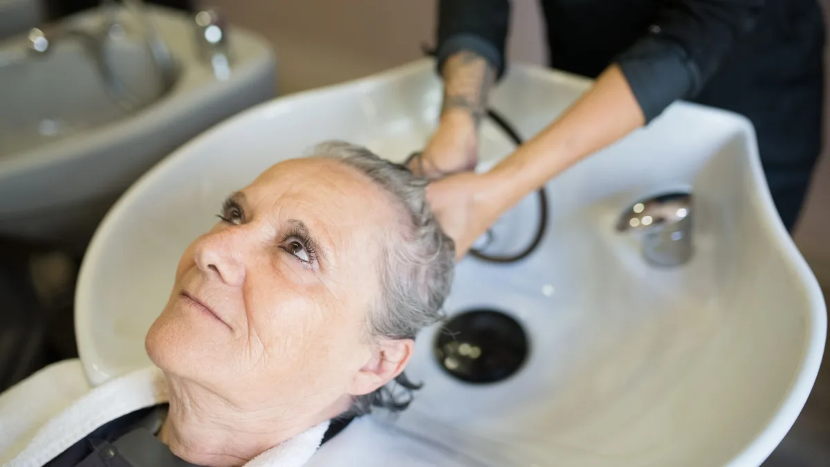 Woman receiving a relaxing hair wash at a salon
