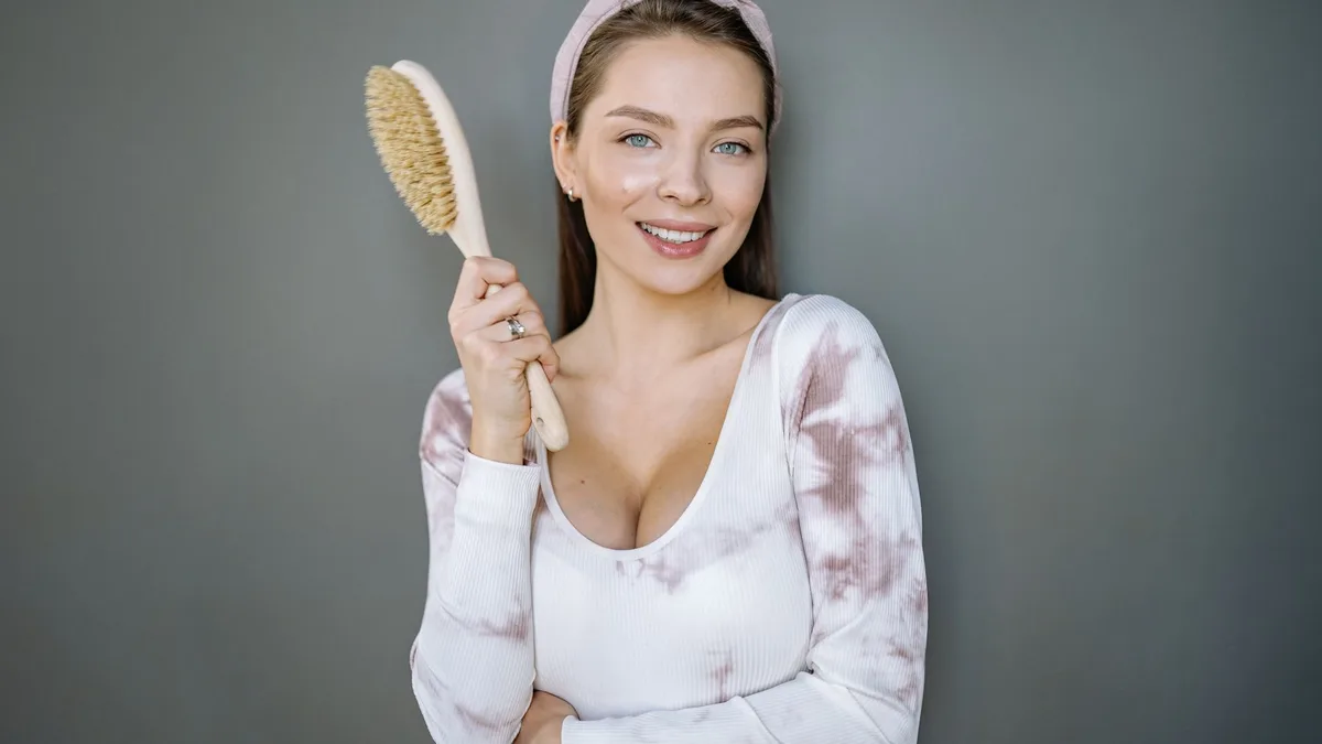Smiling woman holding a hair colouring brush