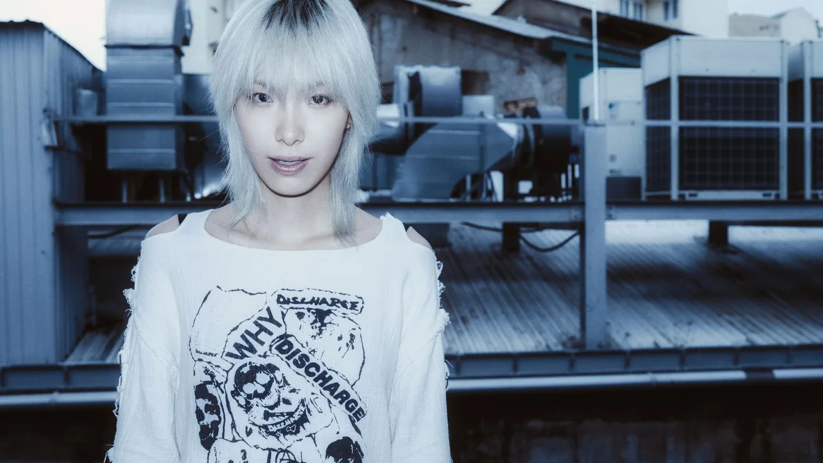 Person with platinum bleached hair in an urban setting