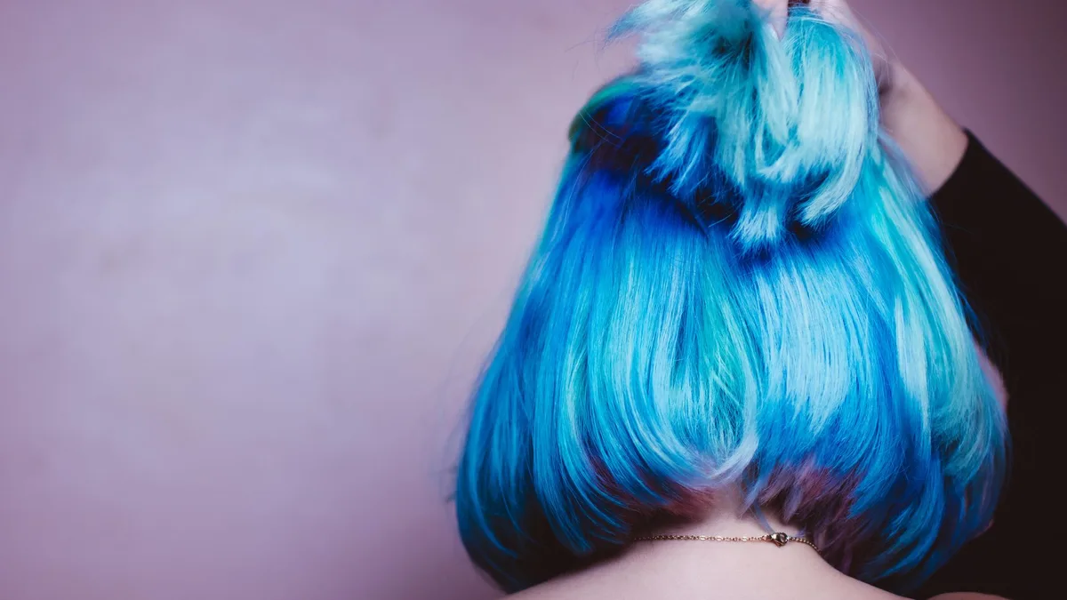 Vibrant blue dyed hair styled into an updo
