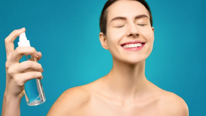 Setting Spray vs Setting Powder Woman applying a setting spray mist to her face