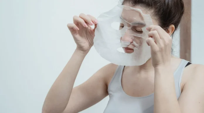 Sheet Masks: How Often to Use Them and What They Can’t Do Woman applying a hydrating sheet mask