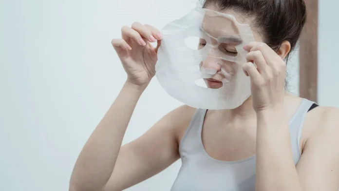 Sheet Masks Woman applying a hydrating sheet mask