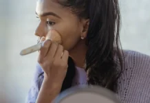 SPF Makeup: Why It Isn’t Enough on Its Own Woman applying foundation makeup with SPF