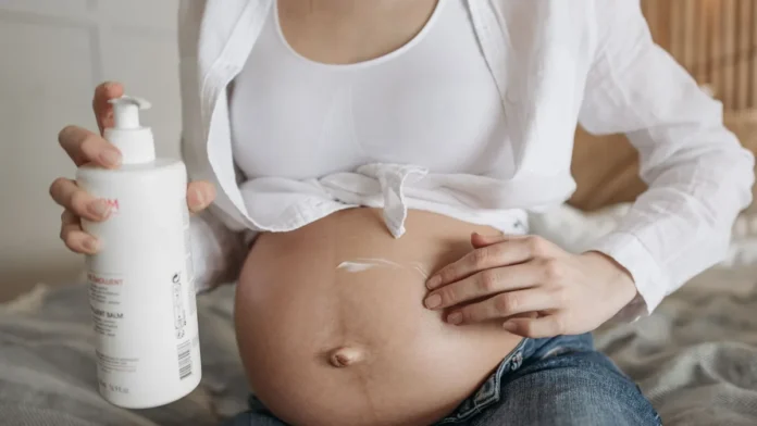 Stretch Mark Creams Applying moisturising lotion to the skin