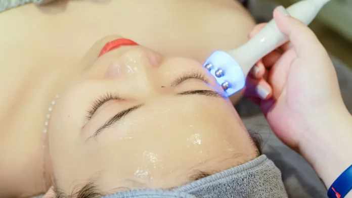 Woman receiving an ultrasonic facial skin treatment