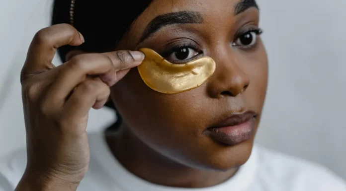 Under-Eye Masks and Patches: Real Benefit or Temporary Fix? Woman applying gold under-eye patches
