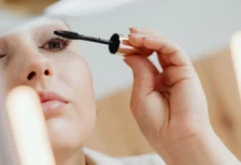 Waterproof Mascara: Removal Without Losing Lashes Woman applying mascara to her eyelashes