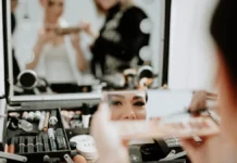 Wedding Makeup: Long-Wear, Flash-Proof and Trial Tips Bride having her wedding makeup applied by an artist