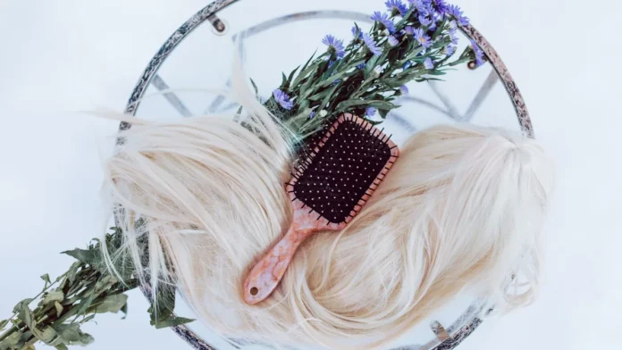 A wig with a brush for wig care and maintenance
