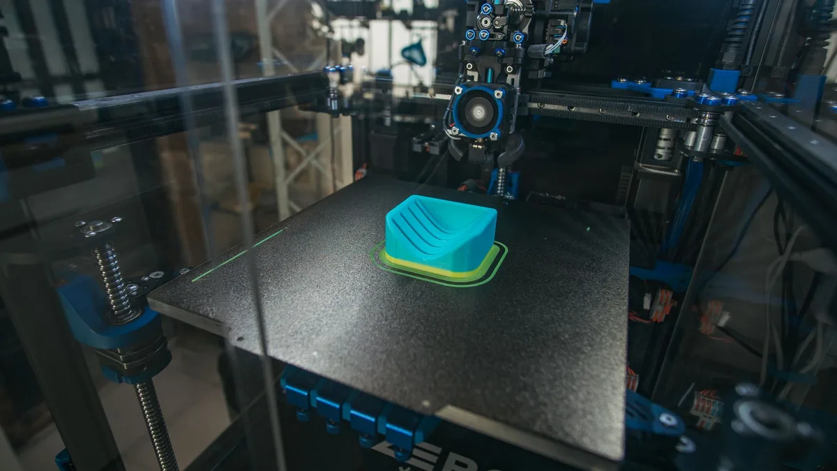 3D printer building a plastic object in an industrial setting