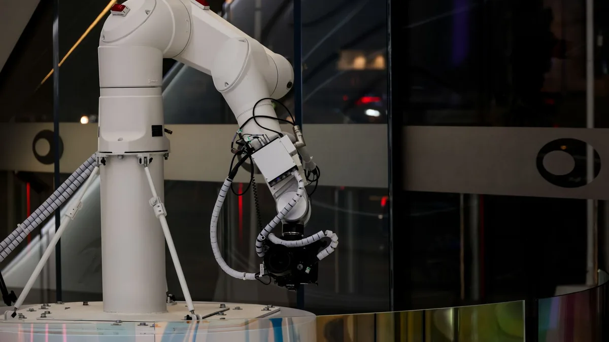 White robotic arm operating in a modern facility