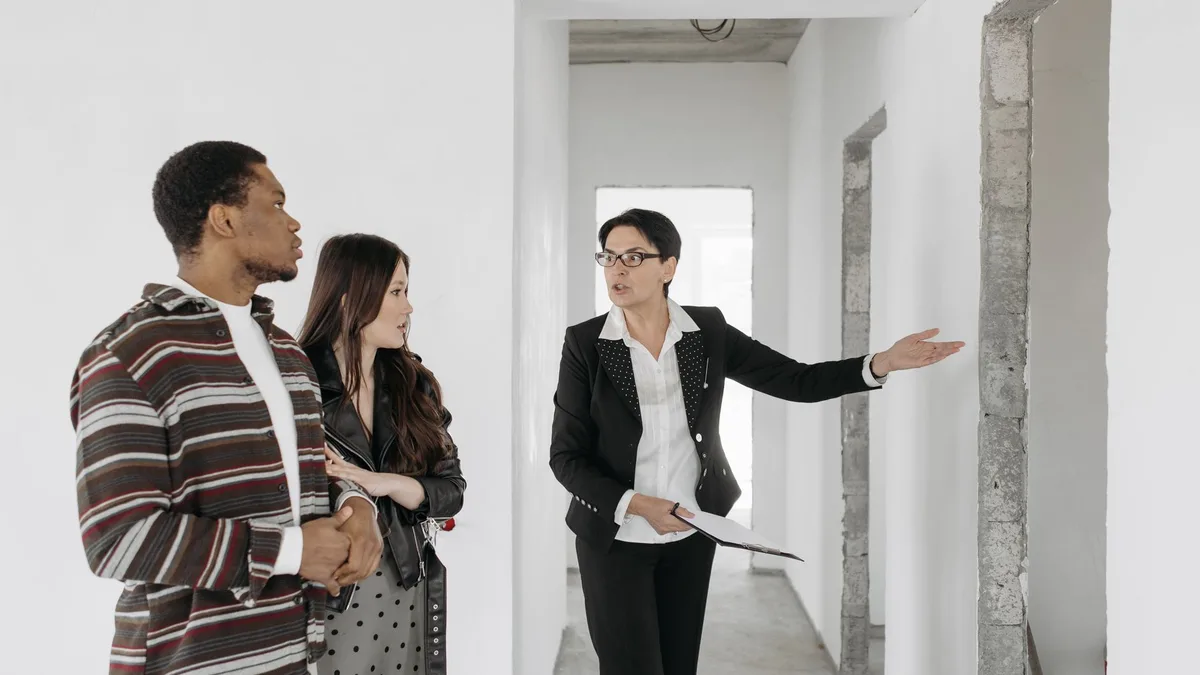 Real estate agent showing a property to a couple