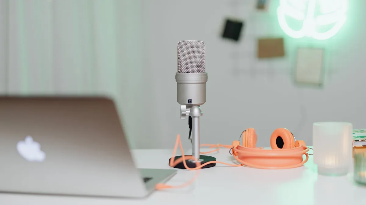 Condenser microphone and laptop on a broadcast desk