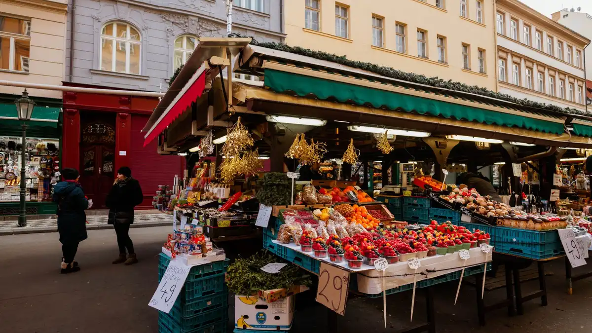 Outdoor market stall stacked with fresh fruit and vegetables