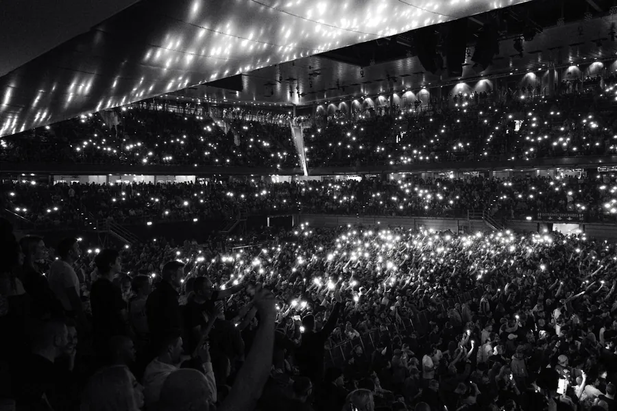 Bill Wyman net worth - black and white image of a concert audience