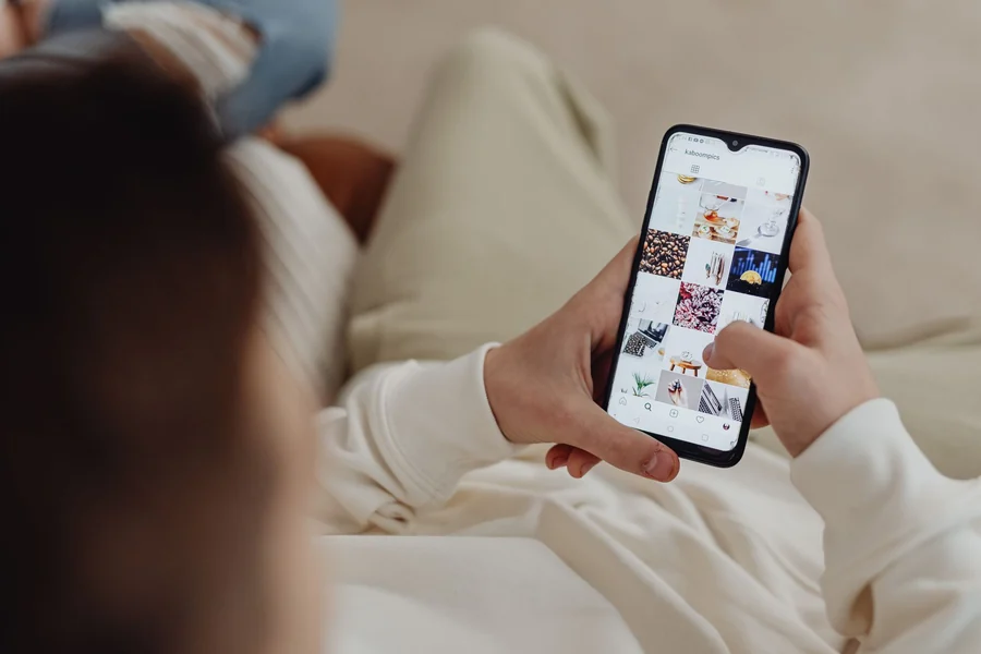 Blackest person in the world - person browsing social media on a smartphone
