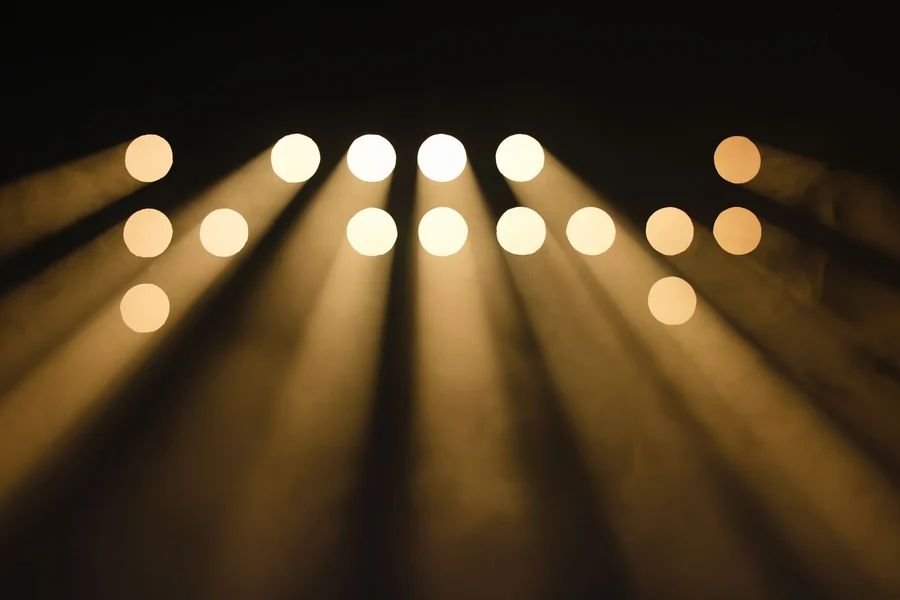 Blackest person in the world - abstract circular light beams on a stage