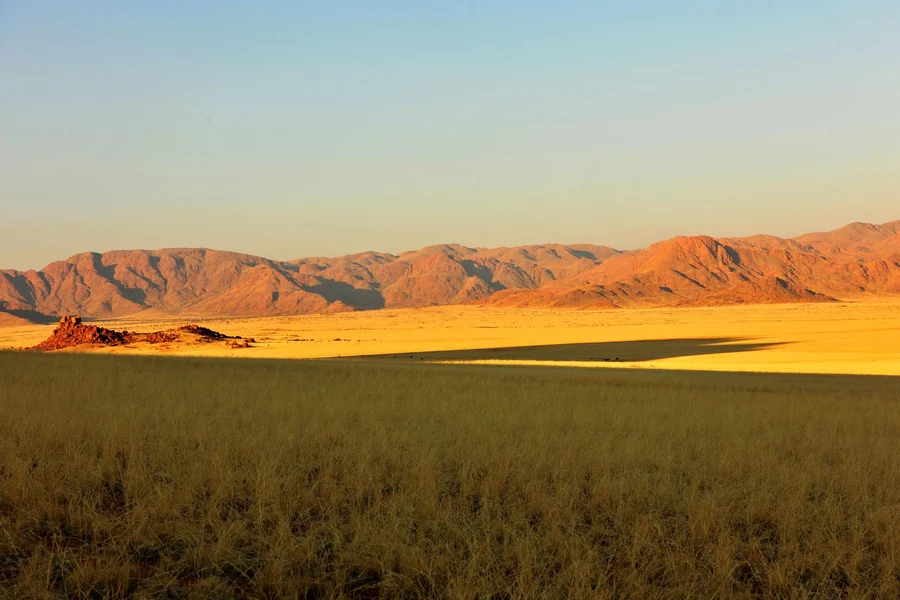 Blackest person in the world - mountains and plains at sunrise in Africa