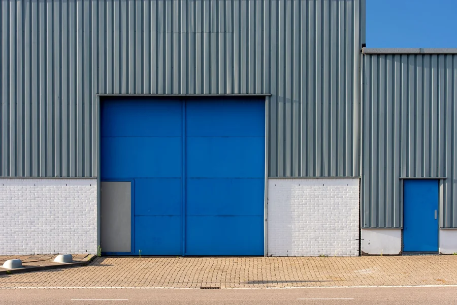Darrell Sheets net worth - metal warehouse with large doors