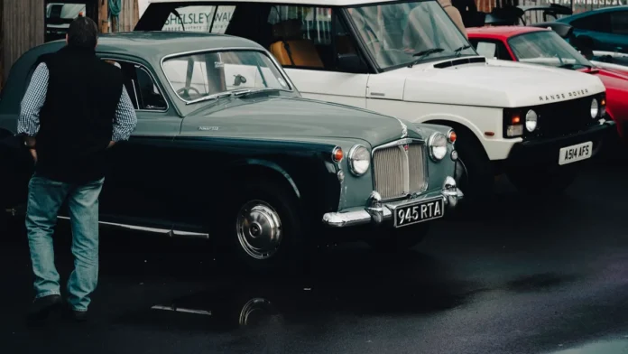 Derek Mathewson Net Worth Row of classic cars on display at a vintage motoring event