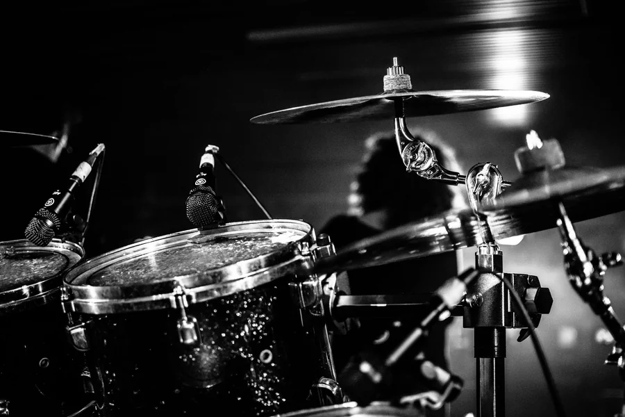 Don Henley net worth - black and white drum kit with microphones on stage