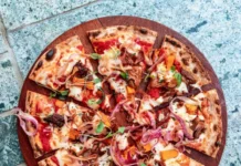 What Is a Double Cut Pizza? And How to Order One Double cut pizza - pizza cut into many small slices on a wooden board