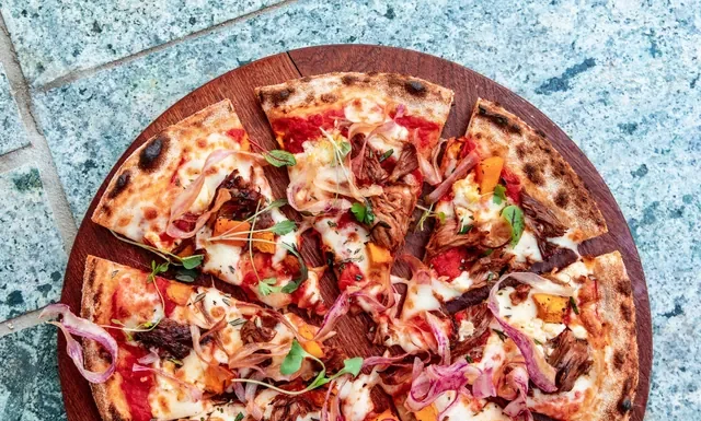 What Is a Double Cut Pizza? And How to Order One Double cut pizza - pizza cut into many small slices on a wooden board