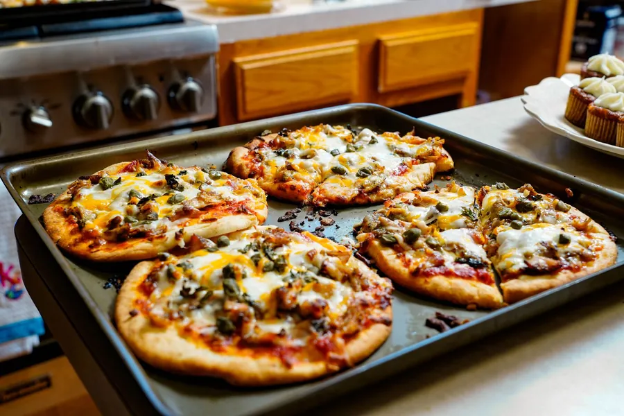 Double cut pizza - freshly baked pizzas cooling on a kitchen counter