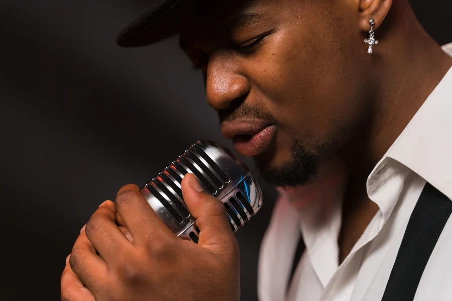 George McCrae net worth - singer performing with a vintage microphone