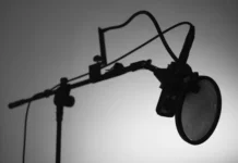 Jay-Z Net Worth 2026: The Four Deals That Built $2.8bn Jay-Z net worth - professional studio microphone on a boom arm in black and white