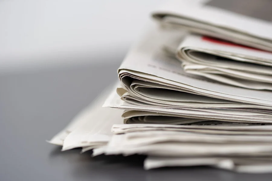 Jimmy Savile - stack of newspapers on a table
