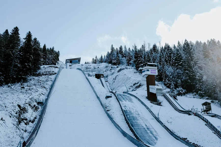 John Candy net worth - winter ski jump among snowy trees