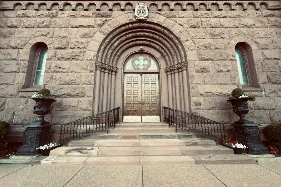 Kesha net worth - ornate stone building entrance with an arched doorway