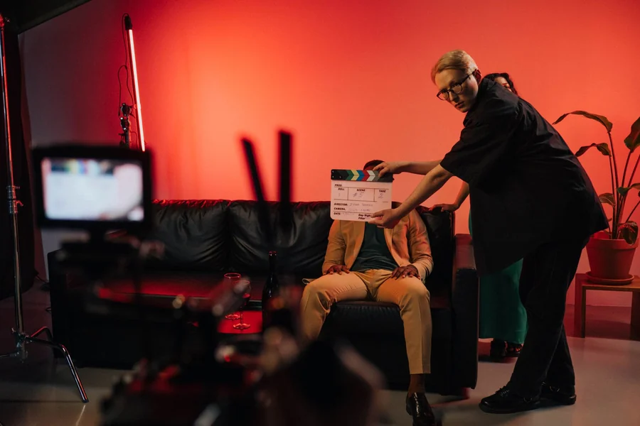 Kevin Spacey net worth - film production team setting up a scene on an indoor set