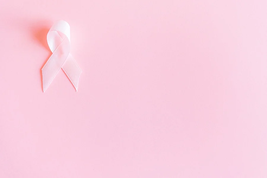 Kylie Minogue net worth - pink breast cancer awareness ribbon