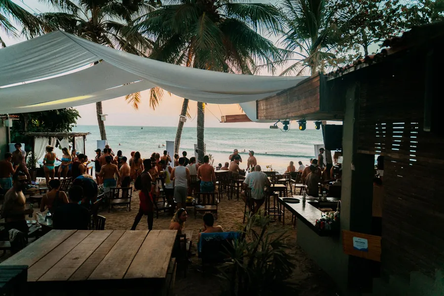 Land Shark beer UK - beachside bar at sunset under palm trees