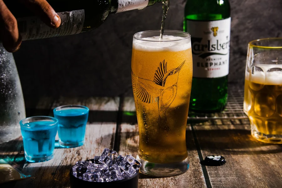 Land Shark beer UK - beer poured into a glass beside bottles on a table