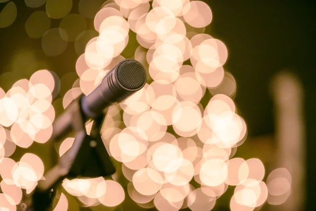 Marie Osmond Net Worth 2026 Marie Osmond net worth - vintage country music microphone on a lit stage