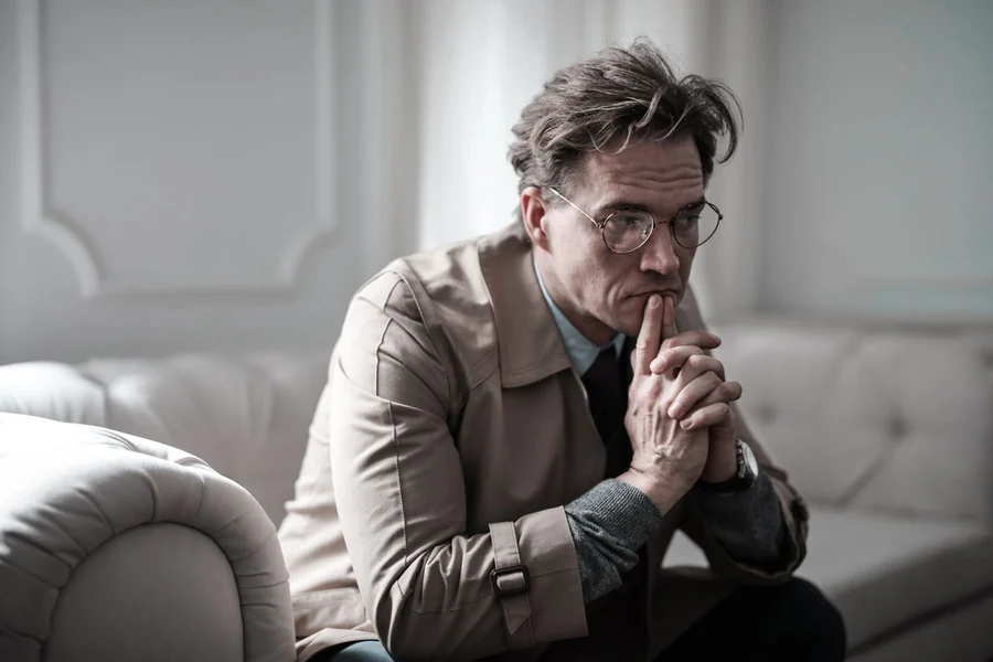 Memory matching game - thoughtful man concentrating on a sofa