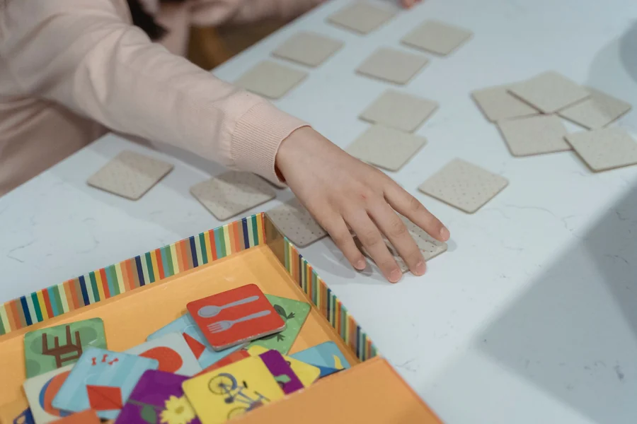 Memory matching game - child concentrating on a card matching game
